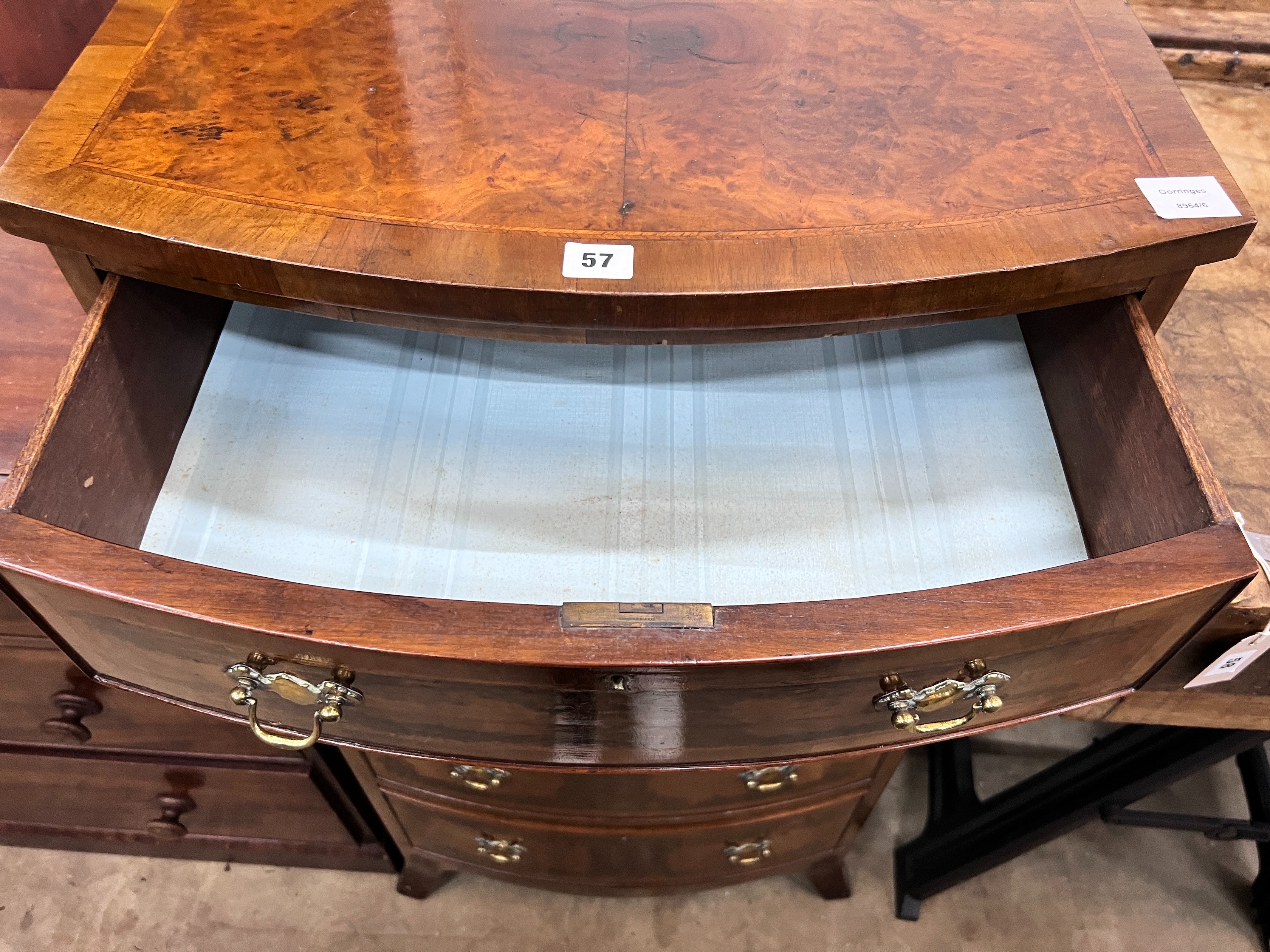 A Queen Anne revival feather banded walnut bowfront five drawer chest, width 61cm, depth 52cm, height 116cm *Please note the sale commences at 9am.